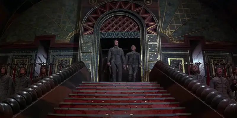 A scene from Dune showing Paul and Gurney standing at the top of an ornate staircase