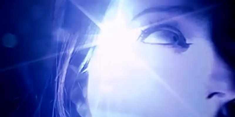 A scene from Inland Empire showing a close shot of Laura Dern looking startled in the dark