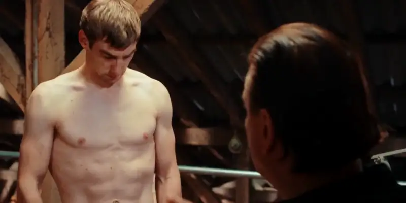 A scene from Streaker showing a naked man (from the belly up), in training for his role as a streaker