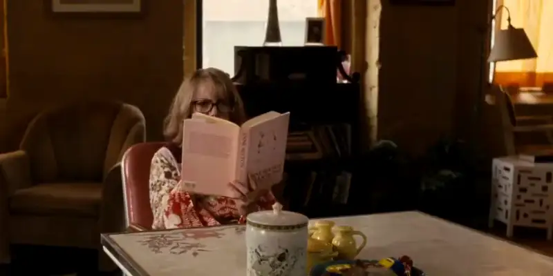 A scene from Synecdoche New York showing Millicent reading a book